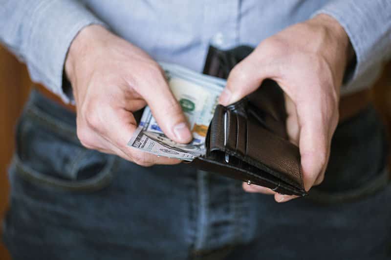 Man removing lost earning from wallet