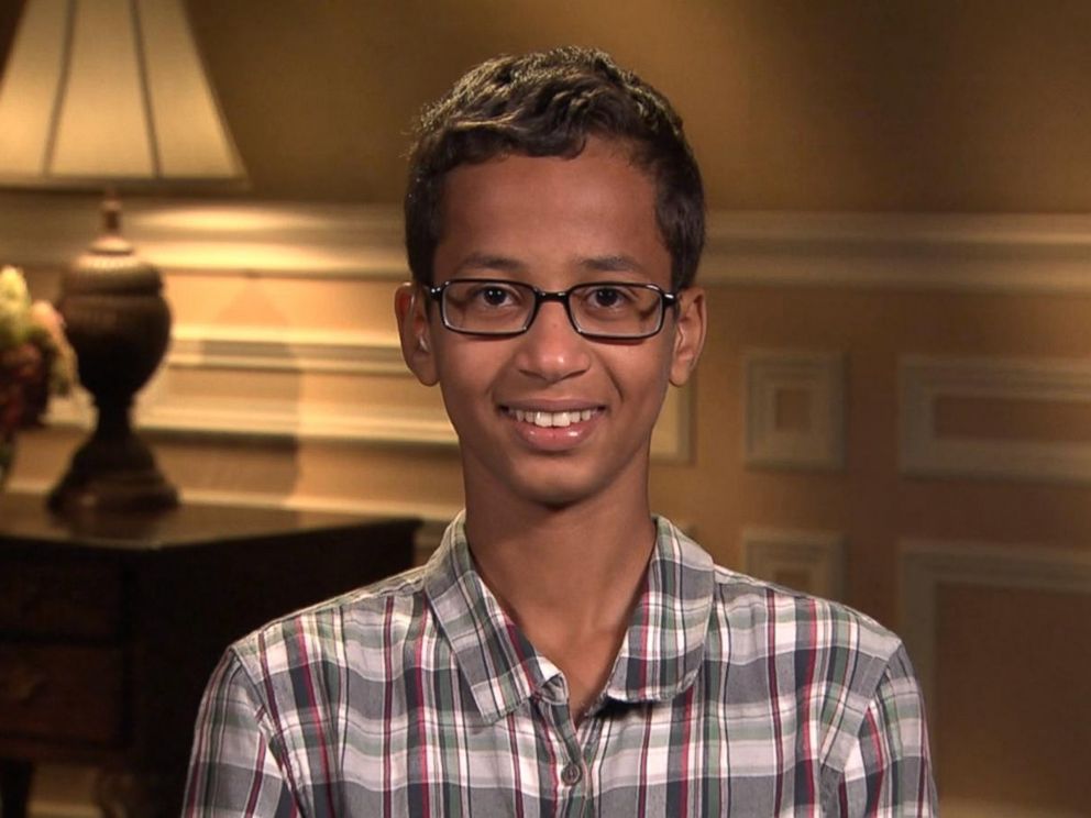 A young man wearing glasses and smiling for the camera.