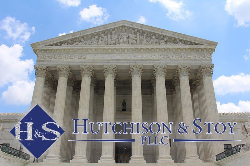 A picture of the front of a building with words " hutchison & stevens llc ".