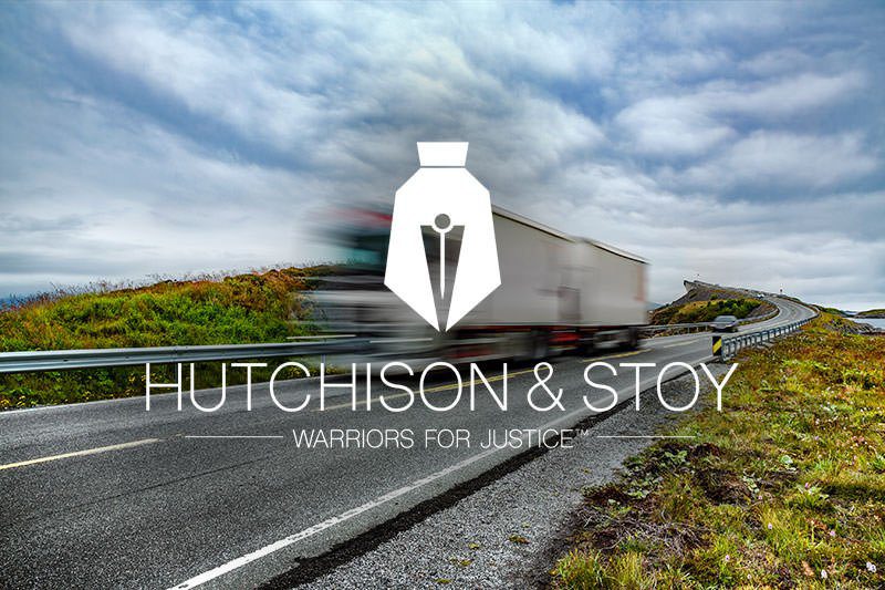 A truck driving down the road with hutchison & stoy logo.